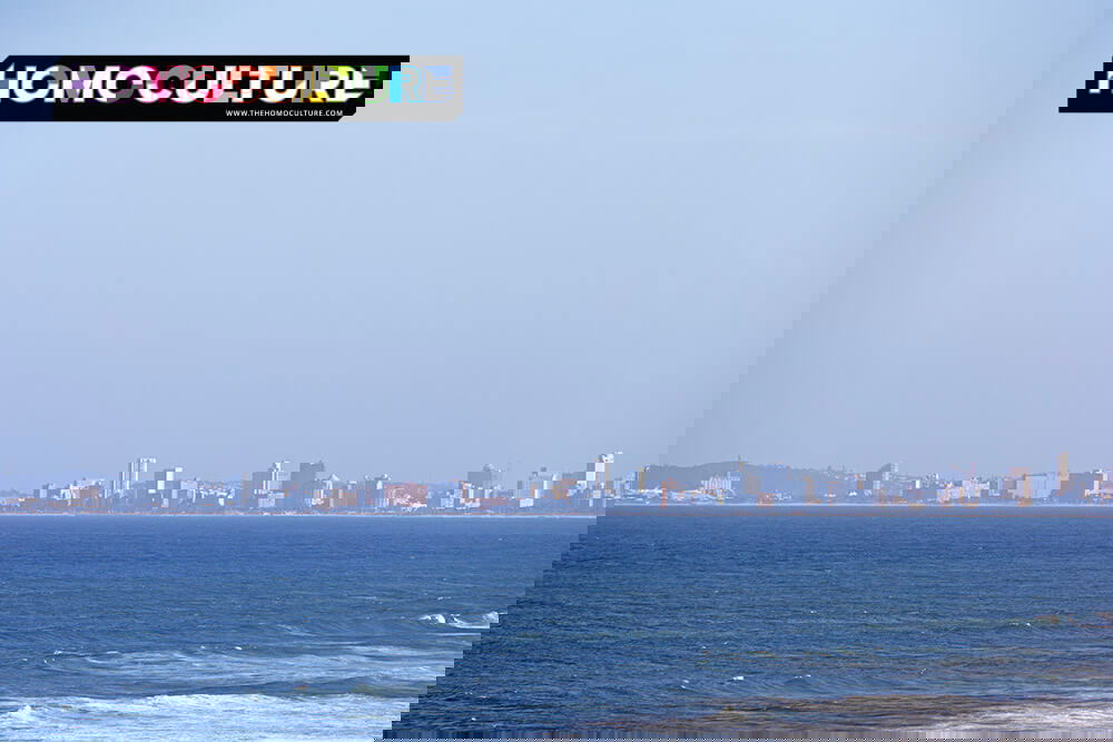 Distant view of Durban skyline across the Indian Ocean under a clear blue sky, photographed from the water.