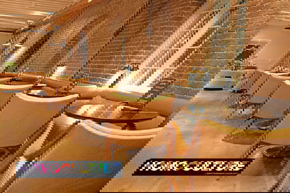 Cozy dining area at ONE11 Hotel’s Batture Bistro + Bar in New Orleans featuring exposed brick walls and intimate seating.